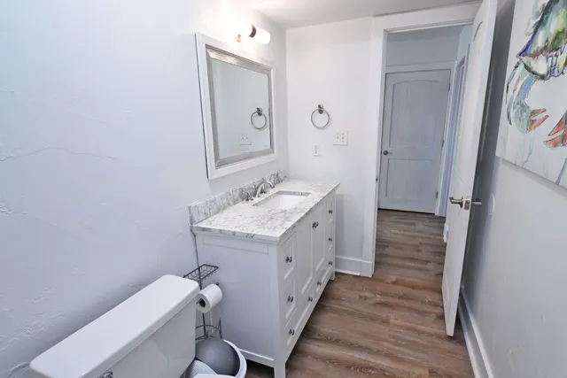 a bedroom with a bed and a painting on the wall