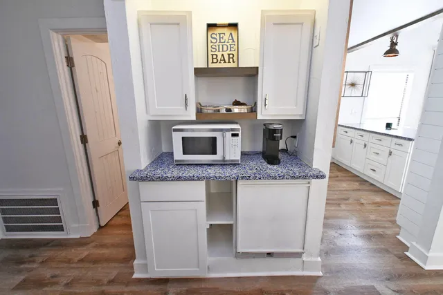 a bed room with a bed and a painting on the wall