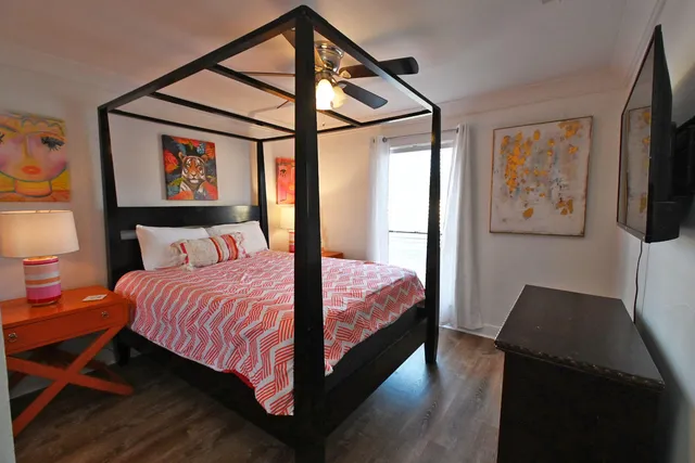 a bedroom with a bed and a flat screen tv