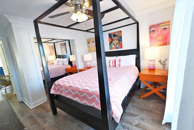 a bedroom with two beds and a chandelier