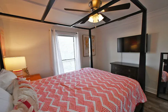 a bedroom with two beds and a chandelier