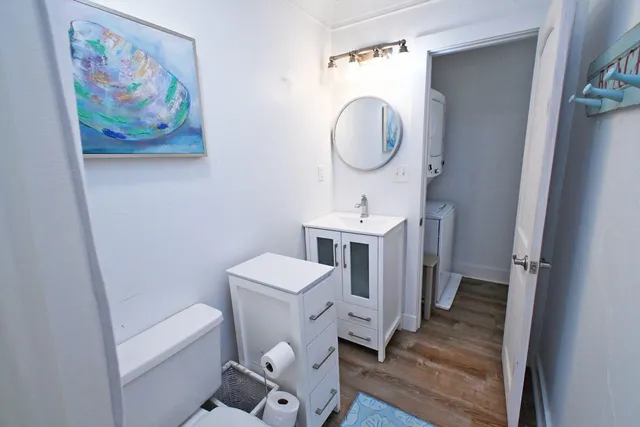 a living room with furniture a flat screen tv and kitchen view