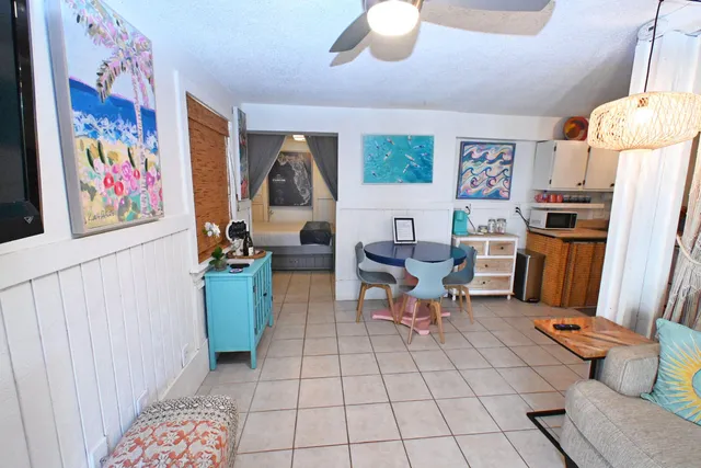 a living room with lots of furniture and refrigerator