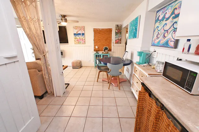 a kitchen with granite countertop a white stove top oven and sink