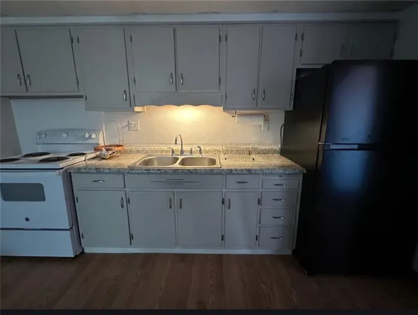 a kitchen with a sink and cabinets