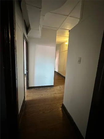 a view of hallway with wooden floor