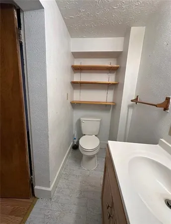a white toilet sitting next to a bathroom sink