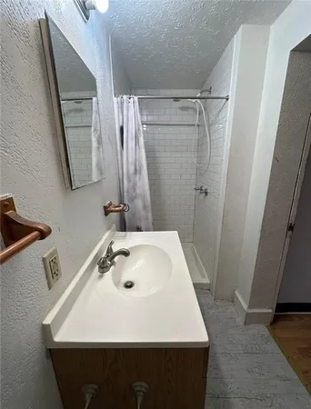 a bathroom with a sink and mirror