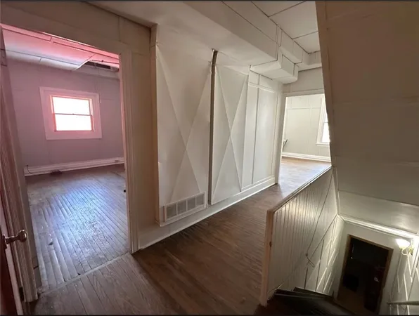 a view of an entryway with wooden floor