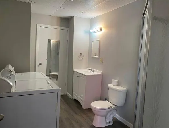a bathroom with a sink toilet and shower
