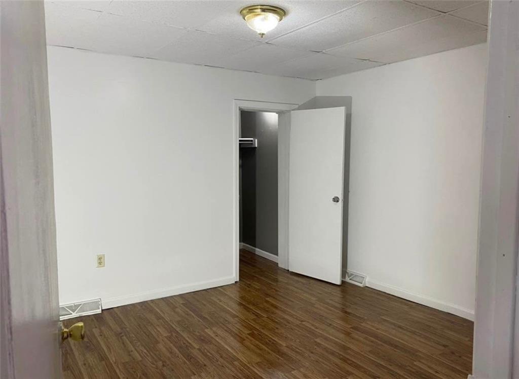 212 5th Street Avonmore, PA 15618 - Photo 7 of 20 a view of an empty room with wooden floor and a window