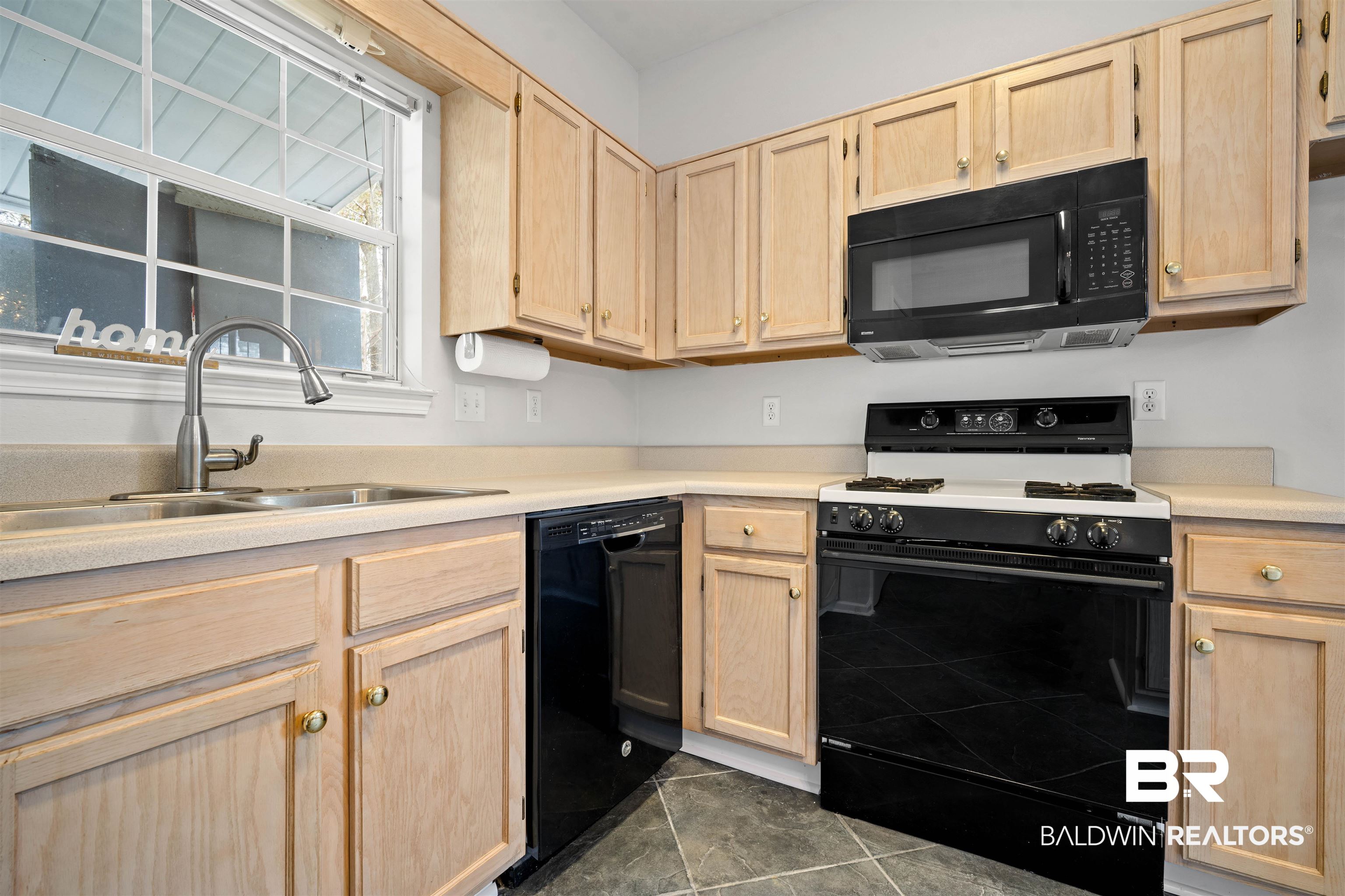250 North Spring Lake Drive Mobile, AL 36695 - Photo 7 of 29 Kitchen featuring light brown cabinetry, black appliances, light countertops, and dark tile patterned flooring