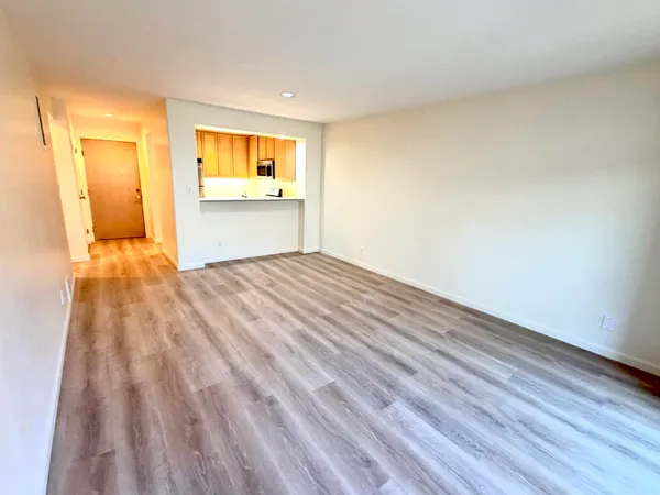 a view of an empty room and a window