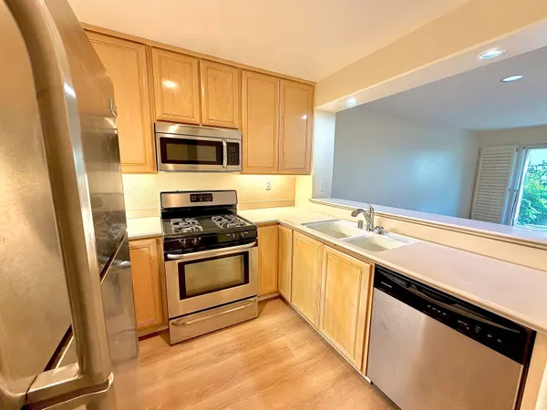 a kitchen with a sink stove and microwave