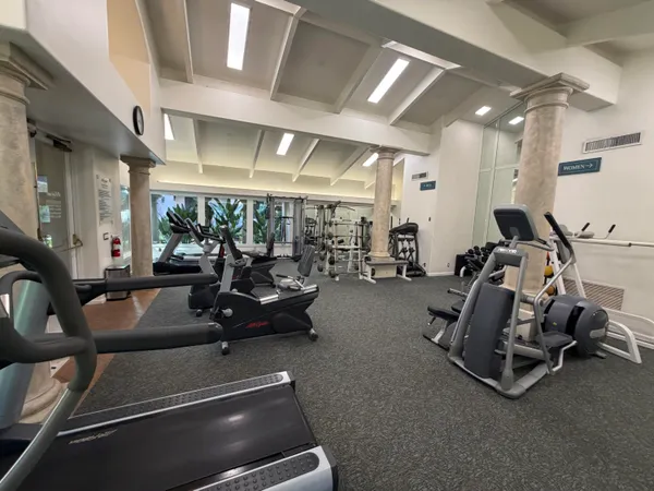 a room with gym equipment and a large window