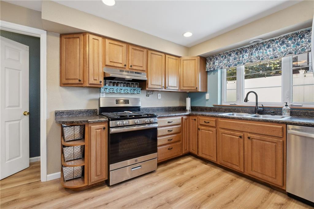 134 Monitor Avenue Pittsburgh, PA 15202 - Photo 15 of 50 a kitchen with stainless steel appliances granite countertop a stove a sink and a microwave