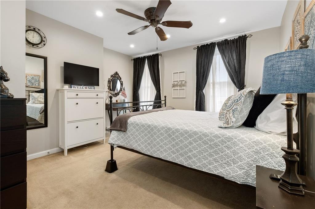 134 Monitor Avenue Pittsburgh, PA 15202 - Photo 24 of 50 a bedroom with a bed and a flat tv screen on dresser