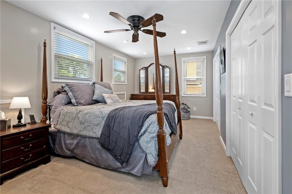 134 Monitor Avenue Pittsburgh, PA 15202 - Photo 33 of 50 a spacious bedroom with a bed and a chandelier