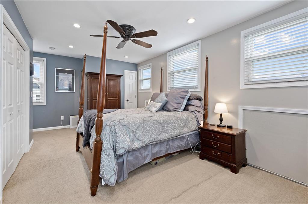 134 Monitor Avenue Pittsburgh, PA 15202 - Photo 34 of 50 a spacious bedroom with a bed and a chandelier