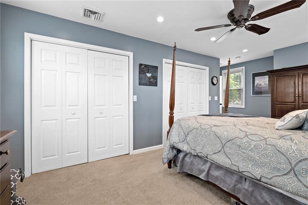 134 Monitor Avenue Pittsburgh, PA 15202 - Photo 35 of 50 a spacious bedroom with a bed and a chandelier