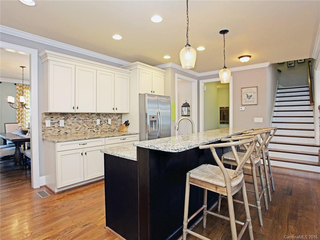 623 Revival Row Fort Mill, SC 29708 - Photo 11 of 24 a kitchen with a table chairs sink and cabinets