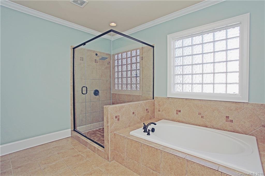 623 Revival Row Fort Mill, SC 29708 - Photo 19 of 24 a bathroom with a bathtub and a shower