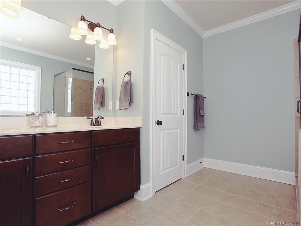 623 Revival Row Fort Mill, SC 29708 - Photo 20 of 24 a bathroom with a granite countertop sink a mirror and a shower