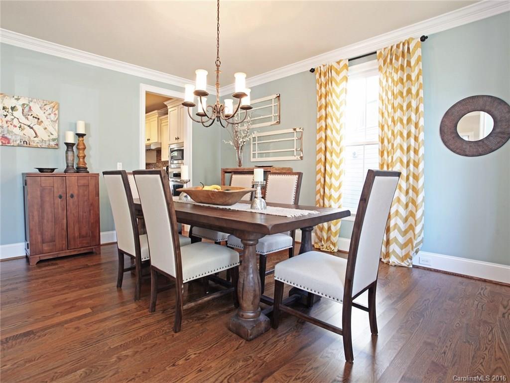 623 Revival Row Fort Mill, SC 29708 - Photo 7 of 24 a dining room with furniture a chandelier and wooden floor