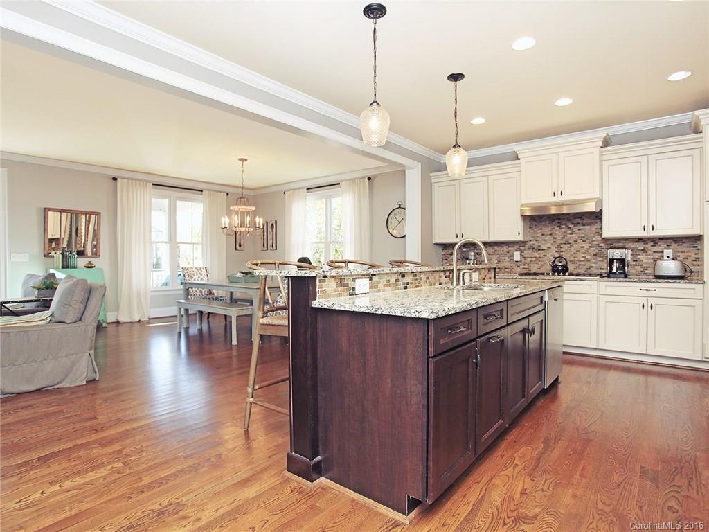 623 Revival Row Fort Mill, SC 29708 - Photo 9 of 24 a large kitchen with lots of counter space a sink appliances and a dining table