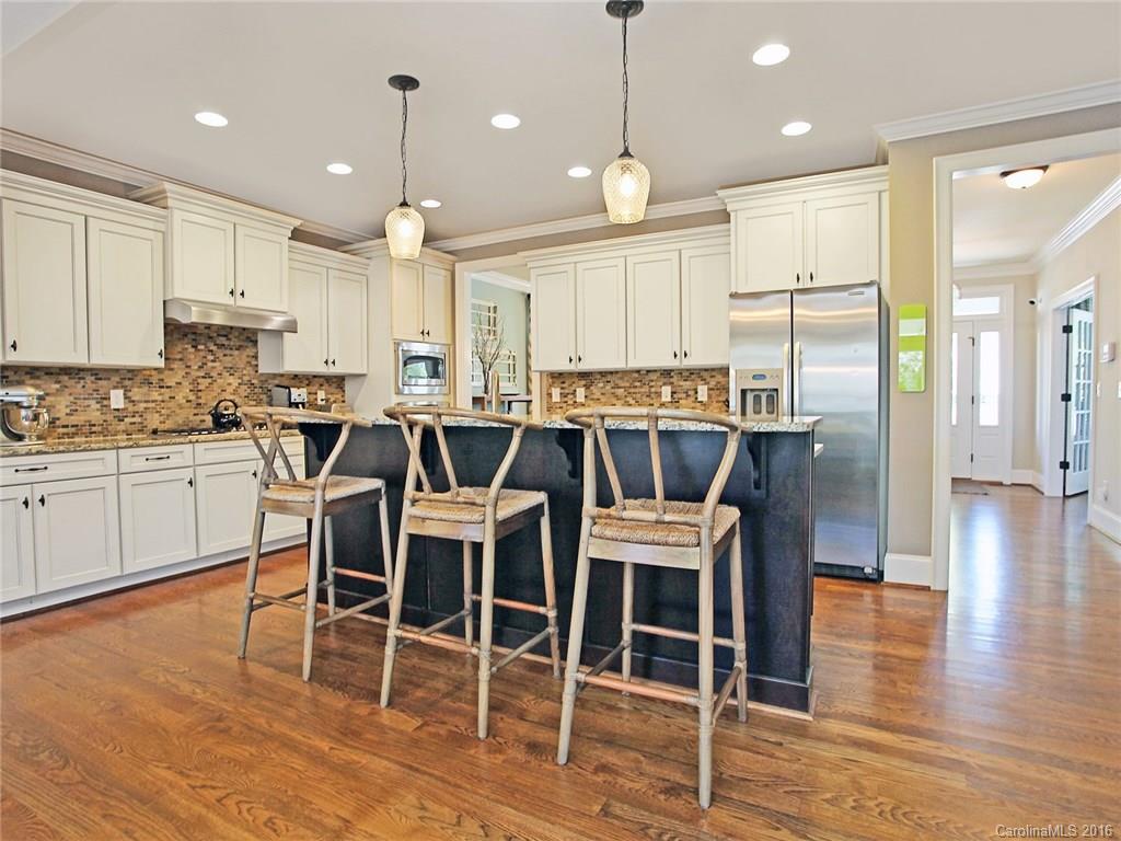 623 Revival Row Fort Mill, SC 29708 - Photo 10 of 24 a large kitchen with a table chairs wooden floor and appliances