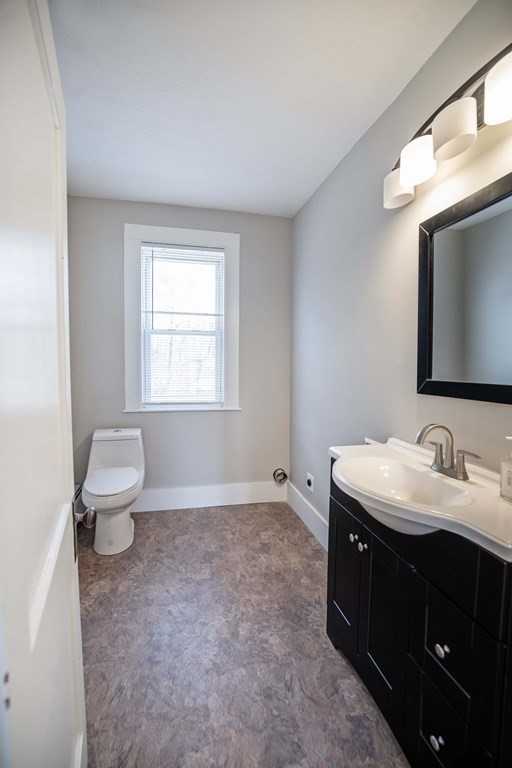 50 Newfields Road, Unit D Exeter, NH 03833 - Photo 12 of 36 a spacious bathroom with a toilet sink and mirror