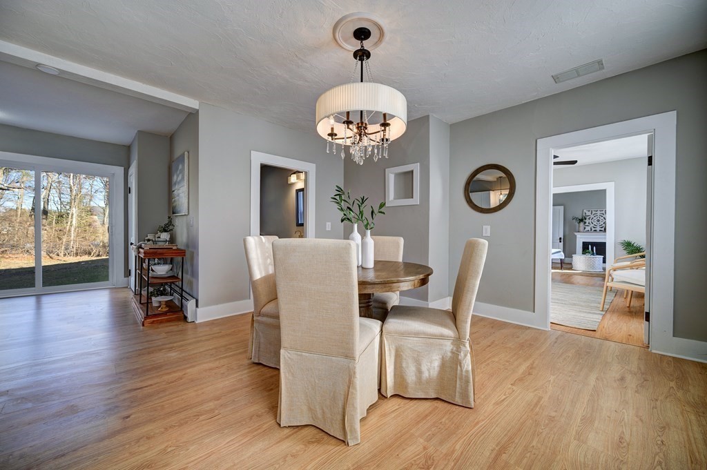 50 Newfields Road, Unit D Exeter, NH 03833 - Photo 14 of 36 a view of a dining room with furniture and wooden floor
