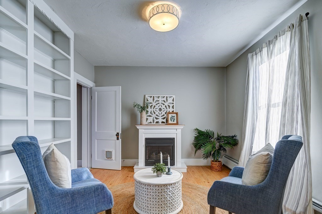 50 Newfields Road, Unit D Exeter, NH 03833 - Photo 20 of 36 a living room with furniture a fireplace and a large window