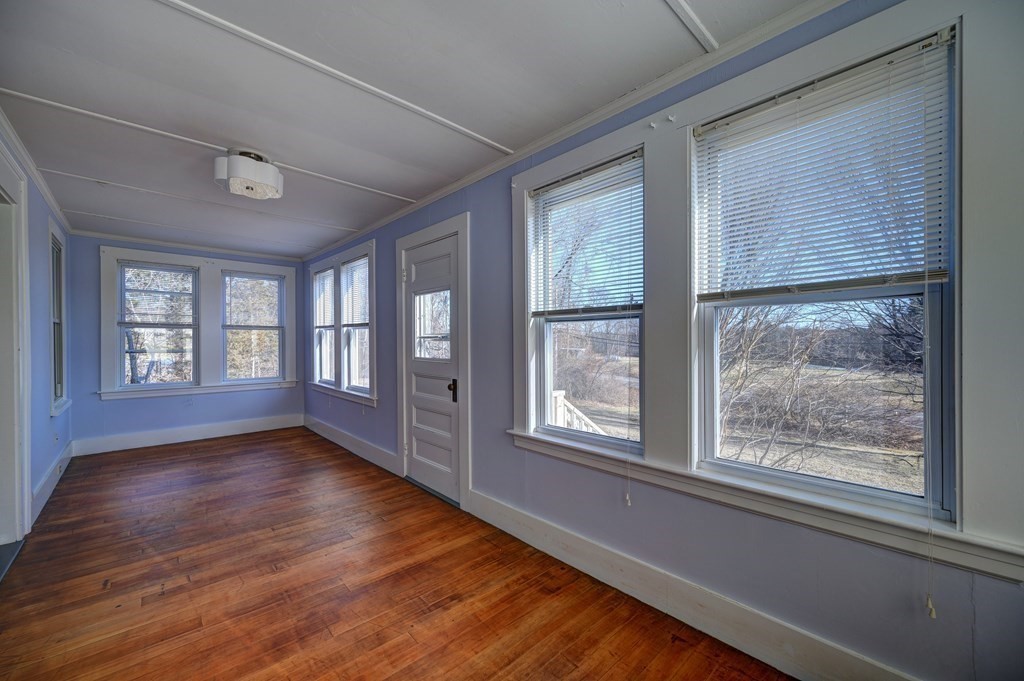 50 Newfields Road, Unit D Exeter, NH 03833 - Photo 22 of 36 a view of an empty room with wooden floor and a window
