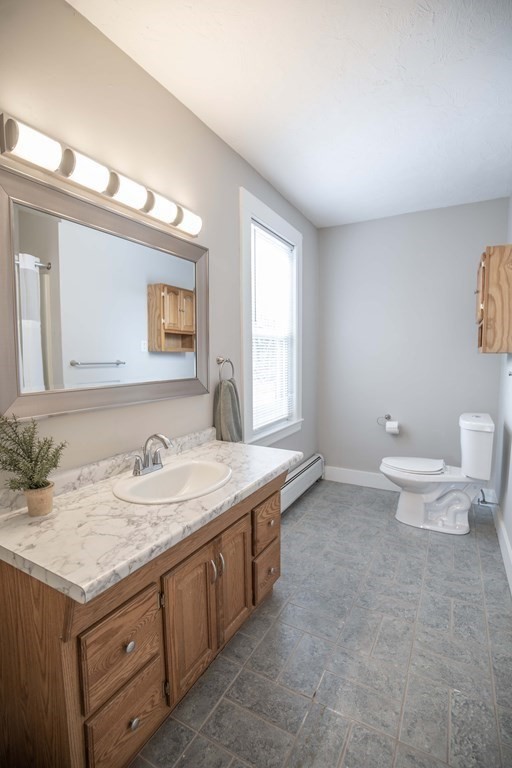 50 Newfields Road, Unit D Exeter, NH 03833 - Photo 25 of 36 a bathroom with a granite countertop sink and a mirror