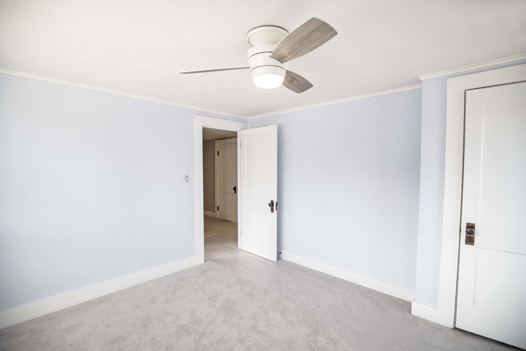 50 Newfields Road, Unit D Exeter, NH 03833 - Photo 29 of 36 a view of an empty room and chandelier fan