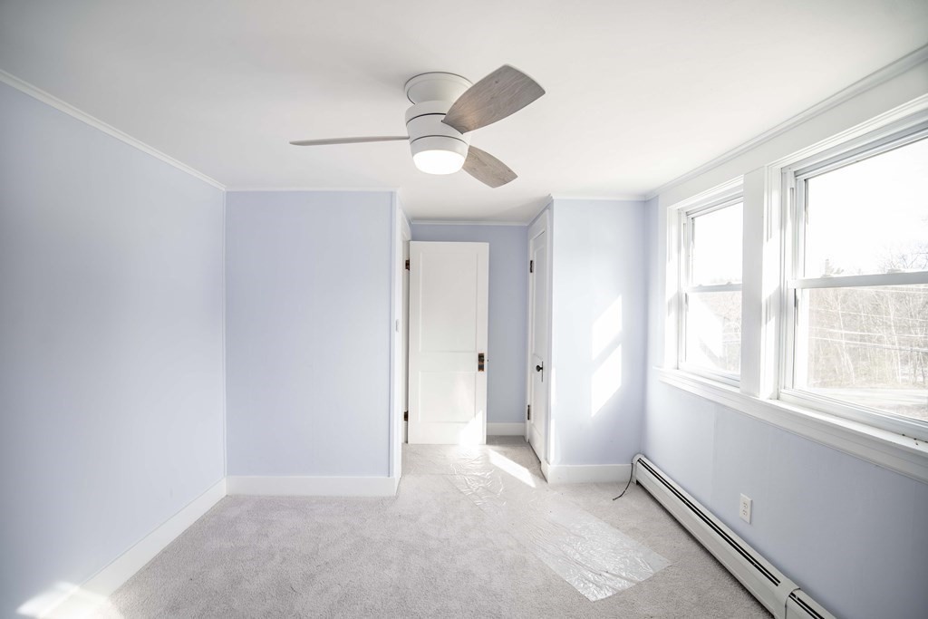 50 Newfields Road, Unit D Exeter, NH 03833 - Photo 30 of 36 an empty room with windows and fan