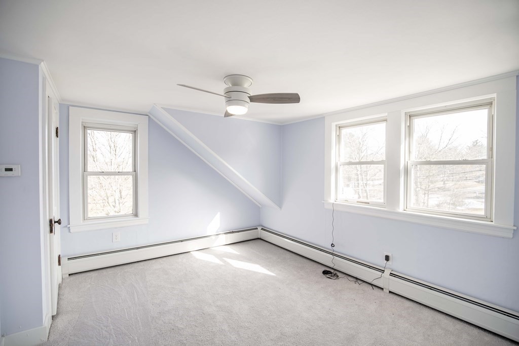 50 Newfields Road, Unit D Exeter, NH 03833 - Photo 31 of 36 an empty room with windows and ceiling fan