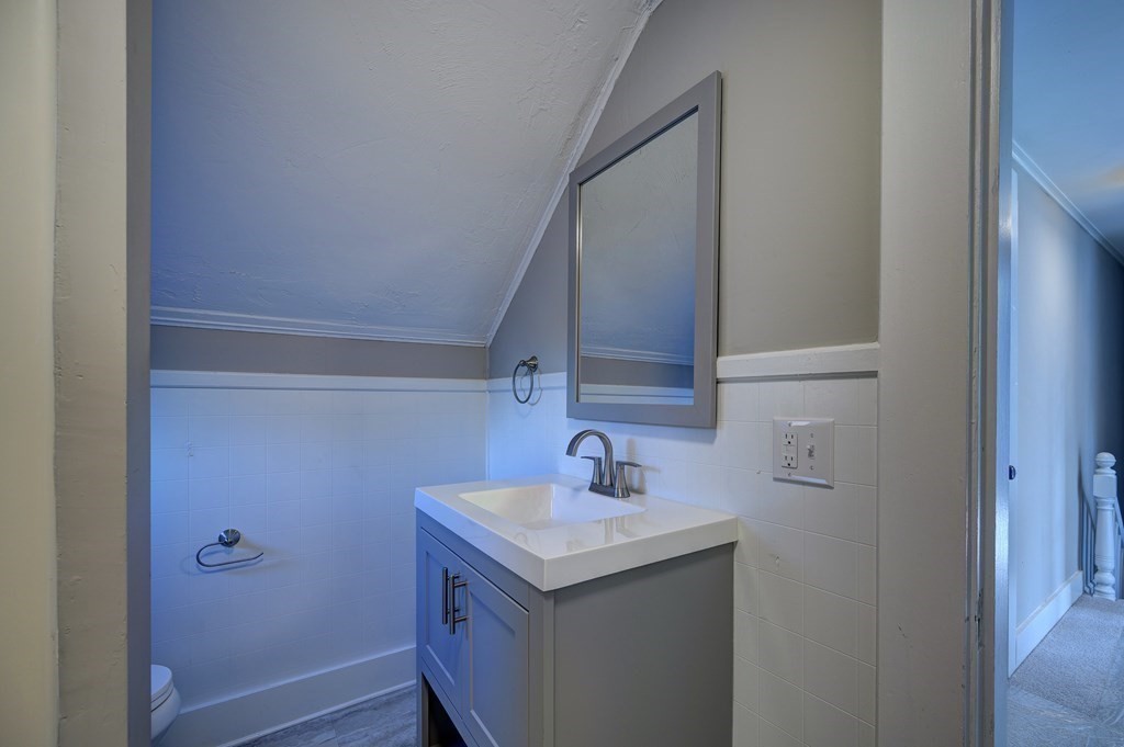 50 Newfields Road, Unit D Exeter, NH 03833 - Photo 35 of 36 a bathroom with a sink and mirror
