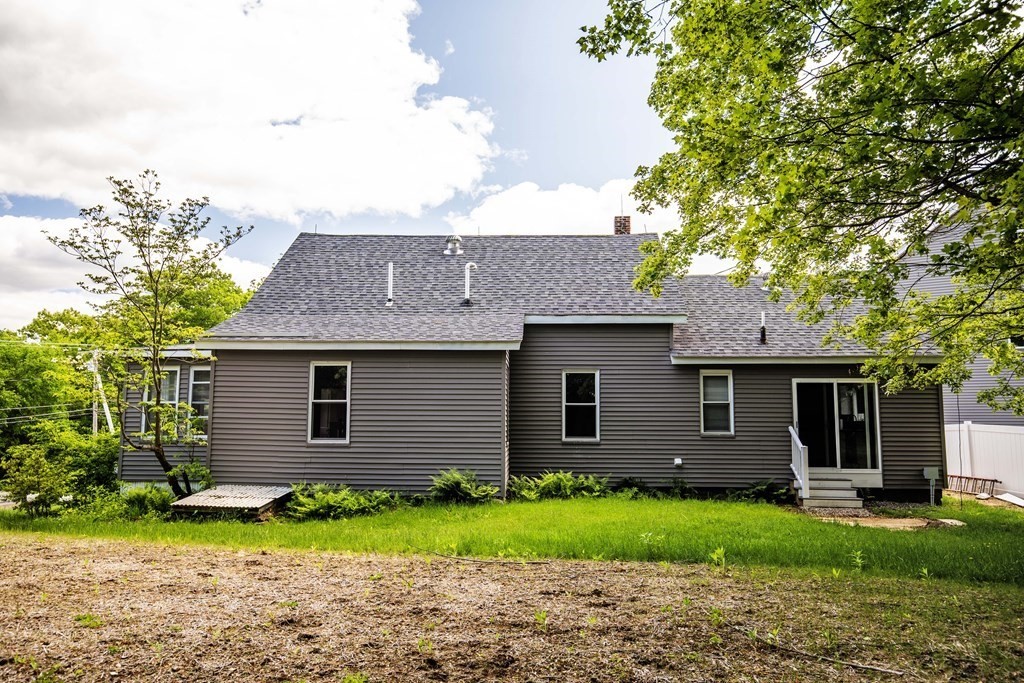 50 Newfields Road, Unit D Exeter, NH 03833 - Photo 5 of 36 a front view of a house with a yard and garage