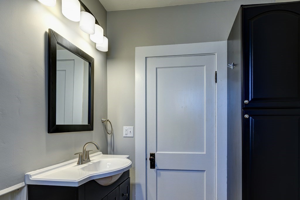 50 Newfields Road, Unit D Exeter, NH 03833 - Photo 10 of 36 a bathroom with a sink and a mirror