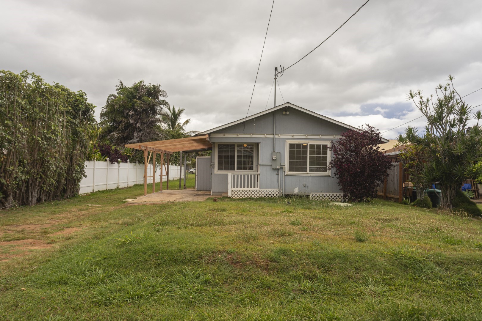 4580 Mamane Street Kapaa, HI 96746 - Photo 27 of 30 a big house with a big yard and large trees