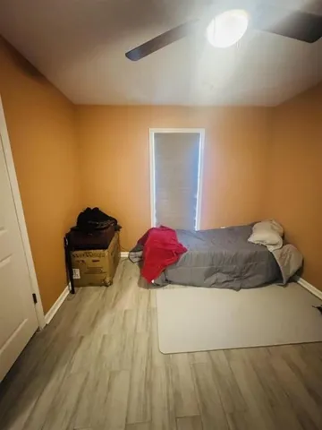 a bedroom with a bed and a potted plant