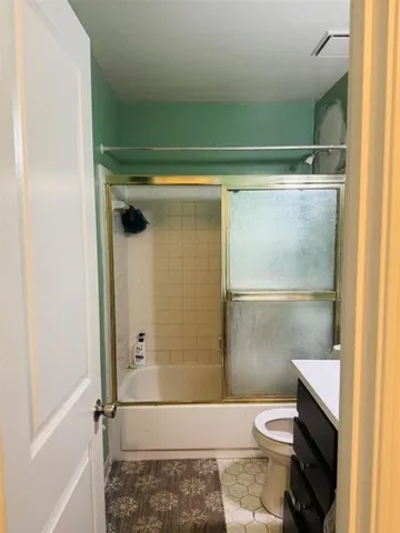 a bathroom with a toilet and a shower