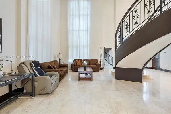 a living room with furniture and a large mirror