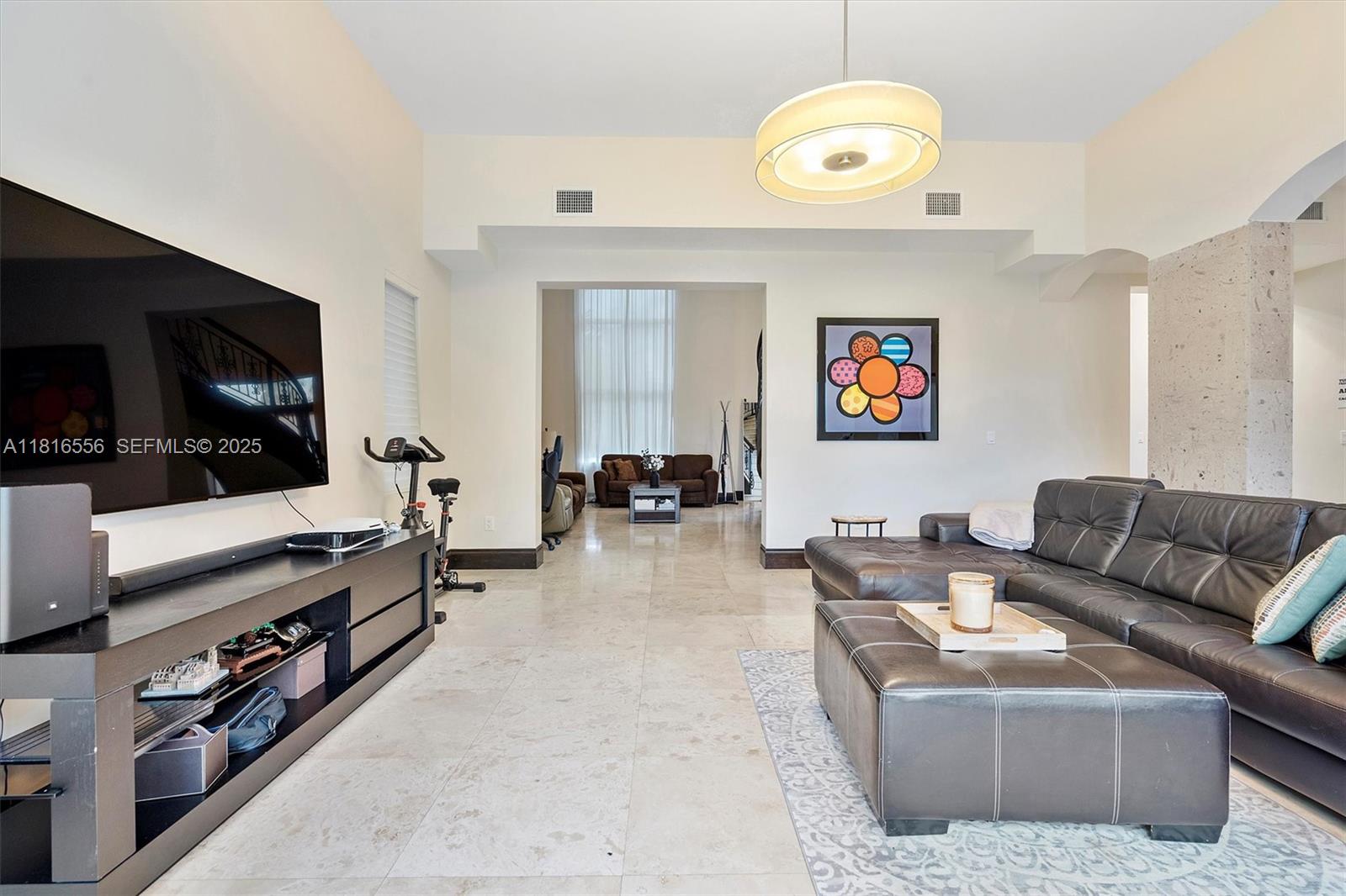 18825 North Bay Road Sunny Isles Beach, FL 33160 - Photo 22 of 62 a living room with furniture and a flat screen tv