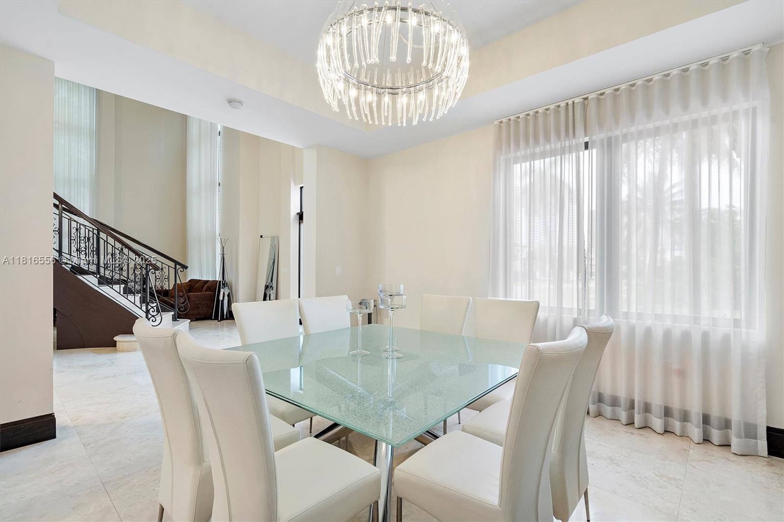 18825 North Bay Road Sunny Isles Beach, FL 33160 - Photo 25 of 62 a dining room with furniture and window