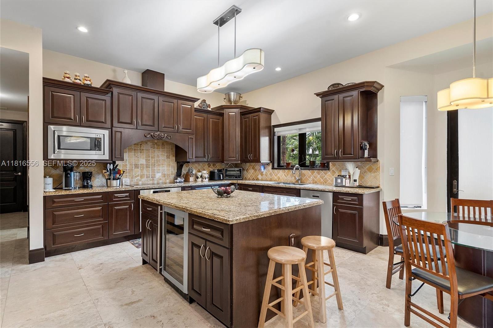 18825 North Bay Road Sunny Isles Beach, FL 33160 - Photo 28 of 62 a kitchen with stainless steel appliances granite countertop a sink a stove and a refrigerator