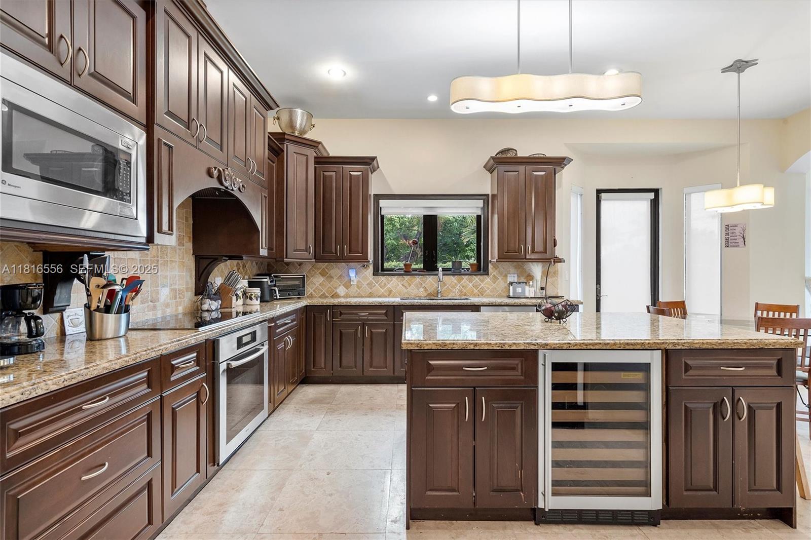 18825 North Bay Road Sunny Isles Beach, FL 33160 - Photo 29 of 62 a kitchen with stainless steel appliances granite countertop a sink and cabinets