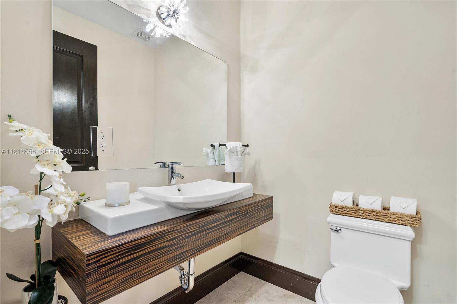 18825 North Bay Road Sunny Isles Beach, FL 33160 - Photo 32 of 62 a bathroom with a sink vanity and a toilet